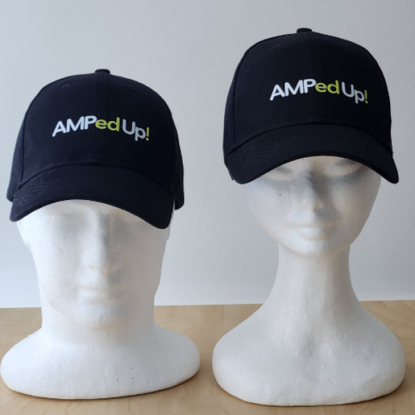 Graphic of a black, baseball style cap, with AMPed Up! text in white and lime green.